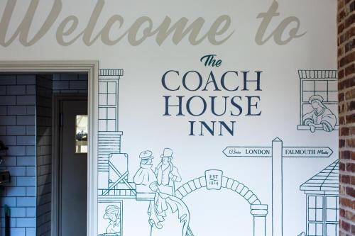 a welcome to the coach house inn sign on a wall at Coach House Inn in Dorchester