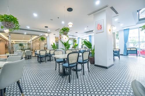 a dining room with tables and chairs at Bao Son International Hotel in Hanoi