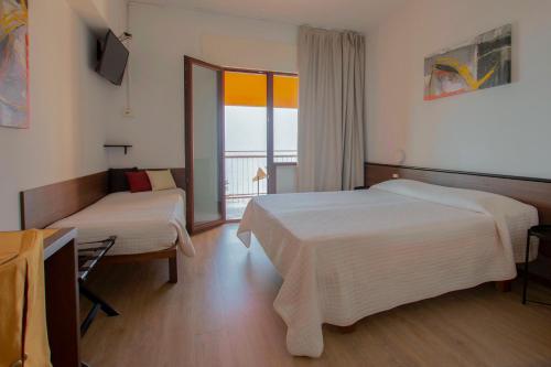 Postel nebo postele na pokoji v ubytování Hotel San Zeno