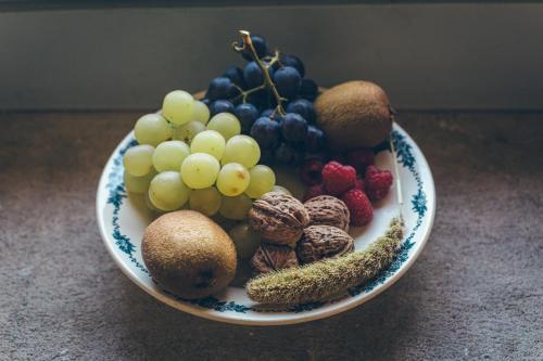 a plate of fruits and nuts on a table at La Ferme Ostalapia in Ahetze