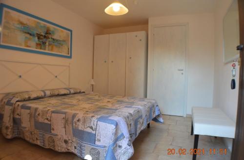 sypialnia z łóżkiem i szafką w obiekcie Villa Rosetta w mieście Chia