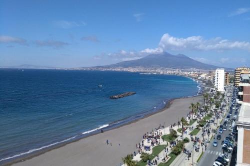 a view of a beach with a mountain in the background at Hotel Stabia in Castellammare di Stabia
