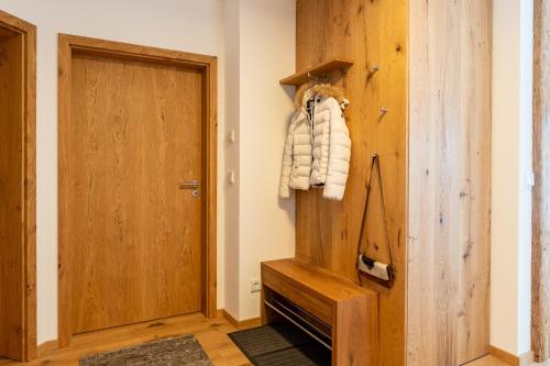 a room with a wooden door and a closet at Zirbentraum in Rettenberg