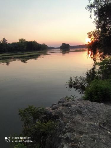 vista para um rio ao pôr-do-sol em Dorino Domaćinstvo em Novi Bečej