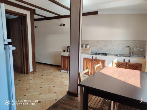 a kitchen with a table and a dining room at Borjomi Sichi in Borjomi