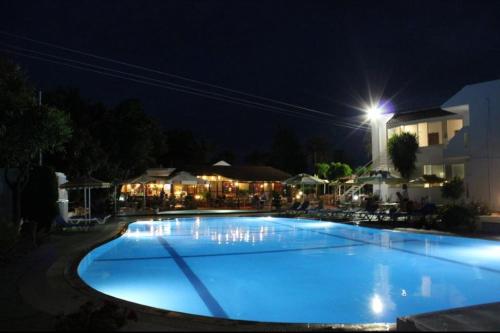 a large blue swimming pool at night at Asterias Bay-Theologos in Theologos