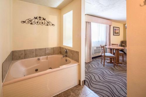 a large bath tub in a room with a table at Quality Inn & Suites Coeur d'Alene in Coeur d'Alene