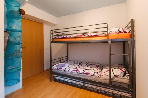 a bunk bed room with two bunk beds at Apartments Lake Bohinj Medja in Bohinj