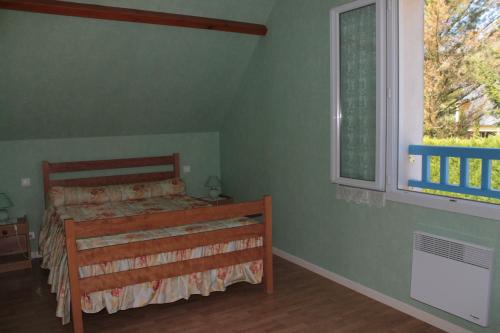 a bedroom with a bed and a window at Gite Ladagnous in Peyrouse