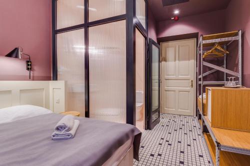 a room with a bed and a closet and a ladder at Neptun Badacsony in Badacsonytomaj
