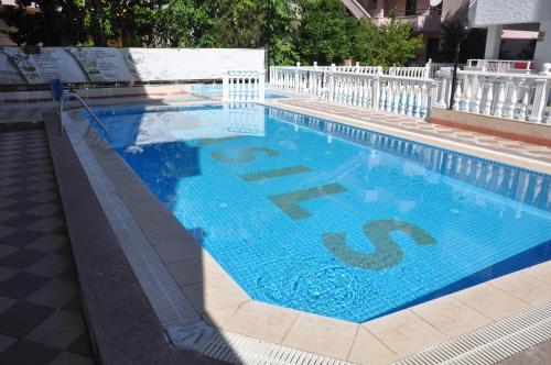 a large blue swimming pool with the letter b on it at BASILS APART HOTEL in Marmaris