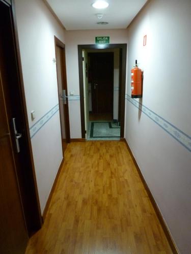 a hallway with a fire extinguisher in a room at Hosteria Sara by gaiarooms in Salamanca