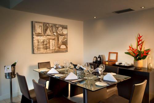 a dining room with a table with wine glasses at Labadi Beach Hotel in Accra