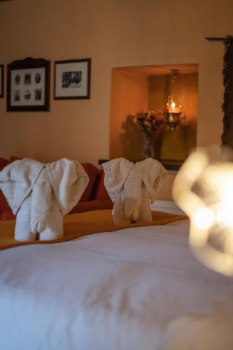 two stuffed elephants sitting on top of a bed at Proselinos in Dhimitsana