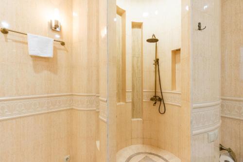 a shower with a glass door in a bathroom at Hotel Flower in Tbilisi City