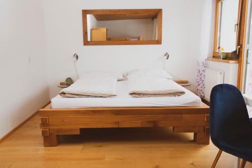 a bedroom with a bed with a mirror on the wall at Lesachtalerhof in Liesing