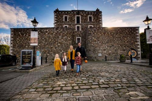 a family walking in front of a castle at The Lodge at Woodenbridge in Arklow