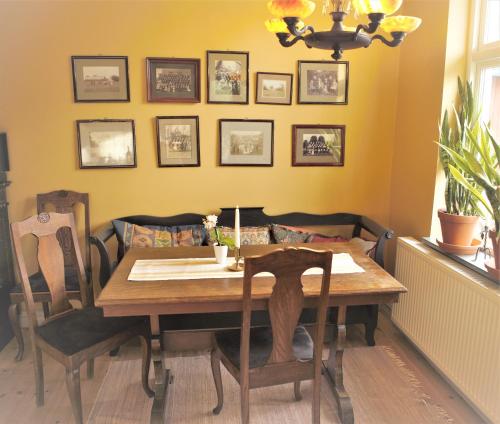 a dining room with a wooden table and chairs at Villa Maria Garden Cottages, Helsingborg in Helsingborg