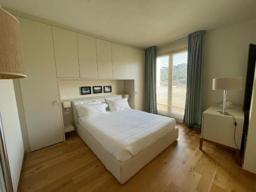 A bed or beds in a room at Appartamenti Vacanze Marina di Scarlino