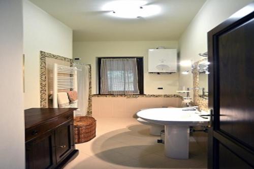 a bathroom with a white sink and a mirror at Country House Arborea in Bagnoregio