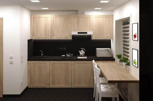 a kitchen with wooden cabinets and a table with a microwave at ART STUDIO 3 in Tashkent