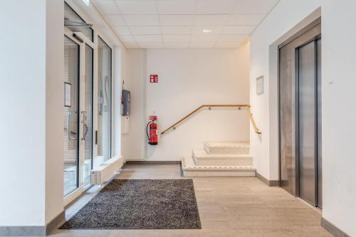 a hallway of a building with stairs and a rug at Apartments Malmö in Malmö
