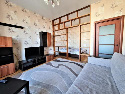 a living room with a couch and a tv at Apartments on Lenina in Mogilev