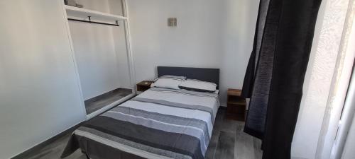 a small bedroom with a bed in a room at Oura - Large Villa - Private Pool - 5 Bedrooms in Albufeira