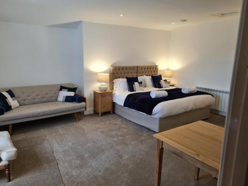 a hotel room with two beds and a couch at No 3 king street apartment and snug in Seahouses