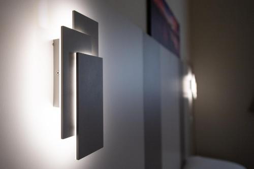 a bathroom with two switches on a wall at Le PALME in Parma