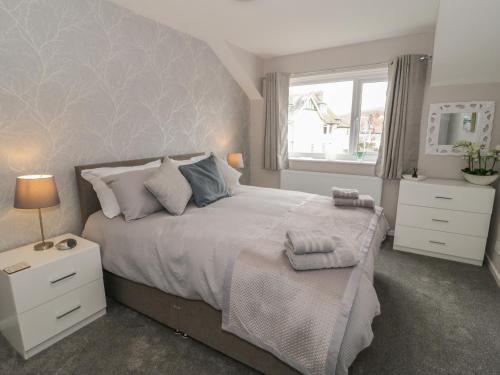 a bedroom with a large bed and a window at 31 Lloyd Street West in Llandudno