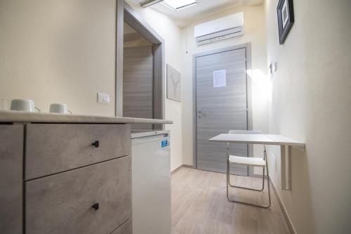 a small kitchen with a table and a small table at Le PALME in Parma