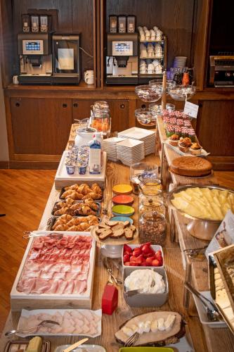 a table filled with lots of different types of food at Hotel Funivia in Bormio