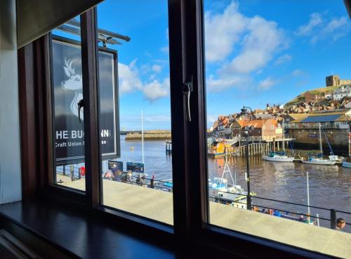 a window with a view of a body of water at The Buck Inn in Whitby
