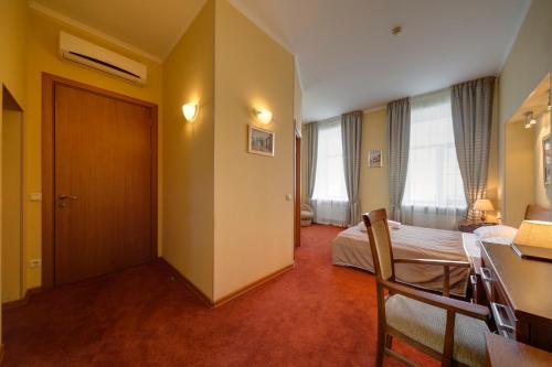 a hotel room with a bed and a desk at Solo Isaac Square in Saint Petersburg