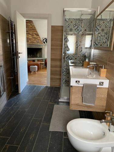 a bathroom with a sink and a toilet and a shower at VILLA NAZZA in Anguillara Sabazia