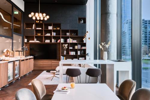 a dining room with a white table and chairs at Crowne Plaza - Warsaw - The HUB by IHG in Warsaw
