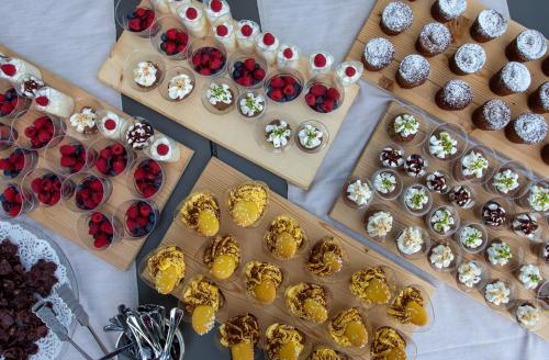 a table topped with lots of gold and silver cupcakes at Hotel Funivia in Bormio