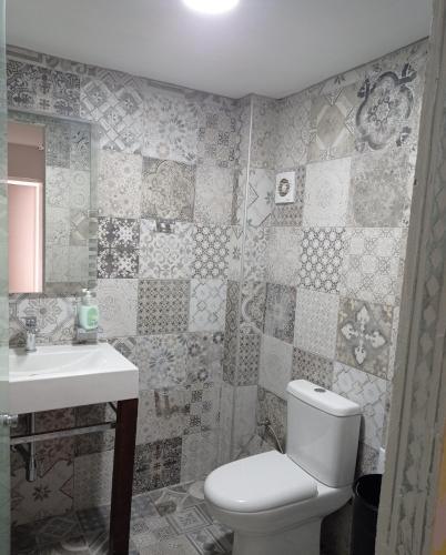 a bathroom with a toilet and a sink at PANORAMA in Pitsidia