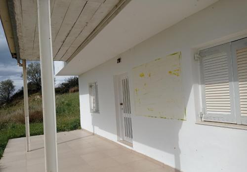 an empty room with a door and a window at PANORAMA in Pitsidia