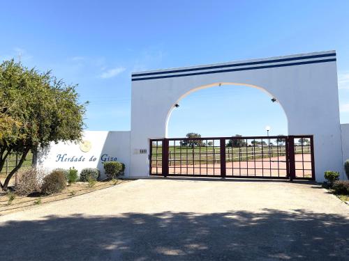 a garage with an open door with a gate at Herdade do Gizo - Casa Reis in Cuba