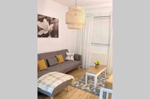 a living room with a couch and a table at Comfy Cardiff Bay Budget Stay with Small Garden 15 mins Walk to Cardiff Bay in Cardiff