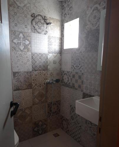 a bathroom with a shower and a sink at PANORAMA in Pitsidia