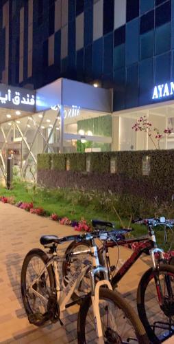 two bikes parked in front of a building at Ayan Hotel in Riyadh