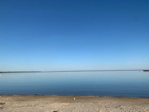 a large body of water with a blue sky at Paradise Inn On the Beach in Port Elgin