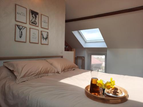 a bedroom with a bed with a tray on it at La Grange d' Angel in Châtillon-sur-Marne