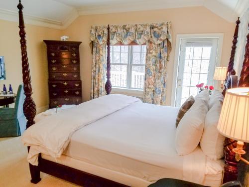 a bedroom with a bed and a window at Copper Beech Inn in Ivoryton