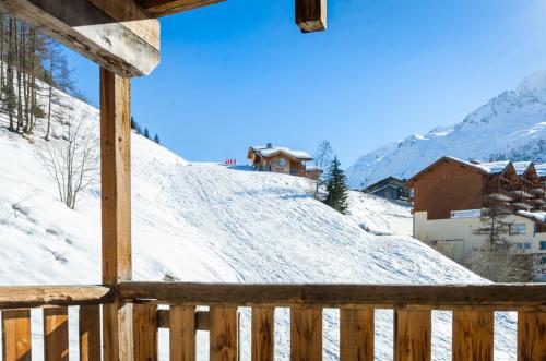 a view of a snow covered mountain from a porch at Black Diamond Sainte Foy Chalets in Sainte-Foy-Tarentaise