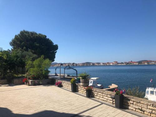 a view of a body of water with flowers at Apartmani Nevena in Brodarica