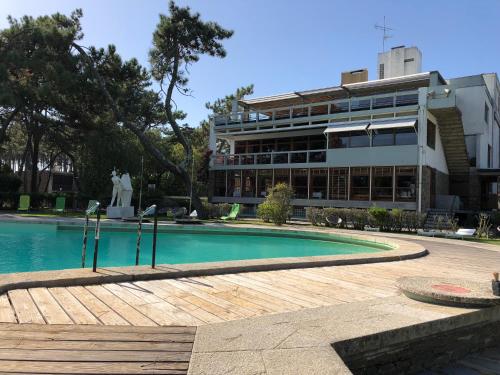 a building with a swimming pool in front of a building at Bungalow B9 - Nature, Beach & River in Fão